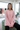Model wearing oversized pink sweatshirt